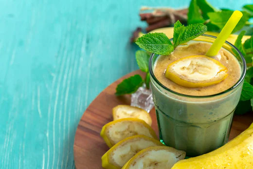 Healthy & Delicious Banana Peanut Butter Smoothie on a blue table, beautifully organized