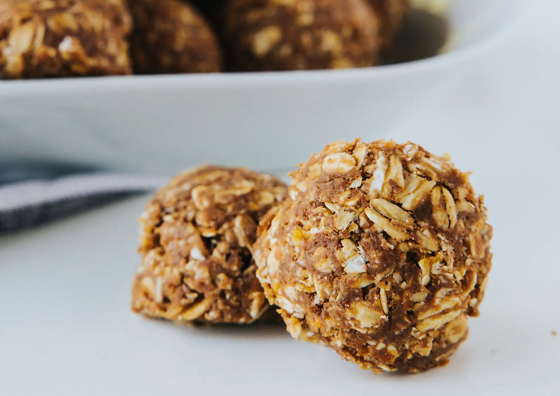 2 Veeg Chocolate Peanut Butter Protein Balls on a white table